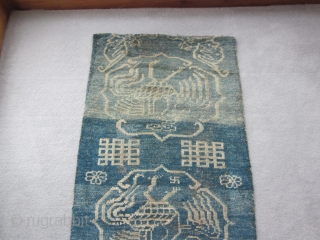 Primitive, village woven Tibetan khaden or runner, 26 by 56 inches. Three large improvised phoenixes in their own cartouches, with other birds at the corners of the piece. Large endless knot motifs  ...