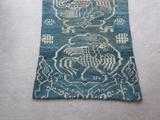 Primitive, village woven Tibetan khaden or runner, 26 by 56 inches. Three large improvised phoenixes in their own cartouches, with other birds at the corners of the piece. Large endless knot motifs  ...