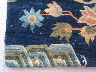 Tibetan sitting mat with phoenix in central rondel,fowers and wave border, about 2 by 2 ft, c.1930                