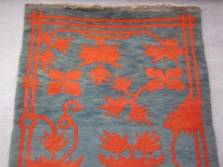 Tibetan khaden, mid-2othC,  35 by 69 inches, large red flowers (?)on exquisitely abrashed greenish-blue ground                 