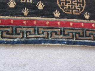 Tibetan : Table mat with two medallions, central endless knot motif, 1'3" by 3'. Some repair to lower border. c.1925             