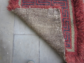 Tibetan wangden sitting  mat with swastika, for temple use, early 20th C. 36 by38 inches                 