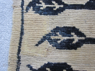 Tibetan, pair of sitting rugs, about 25 by 28 inches, pre-1900, and perhaps earlier. Natural wool ground with tree of life in saturated indigo. Some repair (see extra shot). The eccentric wefting,  ...