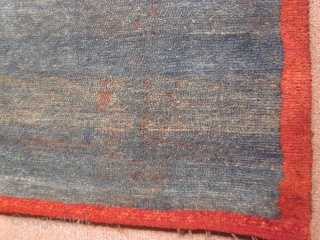 Tibetan, small khaden with abrashed blue green ground, with eccentric red border, 29 by 44 inches, pre-1900                