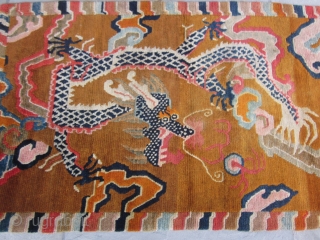 Tibetan khaden with monster dragon cavorting through an orange-grounded, hallucigenic, cloud-banded sky.Don't miss the flaming pearl! Strikingly graphic. c.1920-30 2'10" by 5'8" POR          