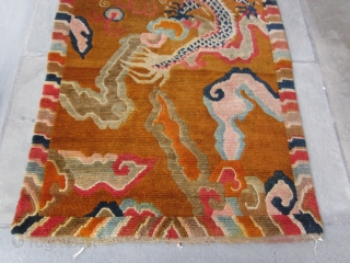 Tibetan khaden with monster dragon cavorting through an orange-grounded, hallucigenic, cloud-banded sky.Don't miss the flaming pearl! Strikingly graphic. c.1920-30 2'10" by 5'8" POR          