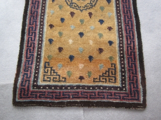 Tibetan khaden with multicolored frog's feet on unusual abrashed yellow ground; pre-1900, 28 by 56 inches;exhibited at 1998 ACOR in Denver            