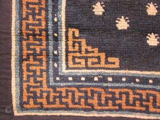 Tibetan: Small khaden, 27 by 52 inches, field of "frogs feet" with central medallion on deep blue ground. Some re-weaves  c.1900           