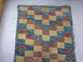 Tibetan, multi-colored checkerboard design in Wangden construction, but not for monastic use. About 1900, possibly before. Scattered small repairs. Size about 2 1/2 by 5 ft       