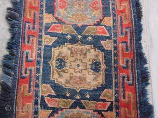 Tibetan long three "gul" khaden with blue fuzzy border, post-1900, 32 by 64 inches, excellent condition.                 