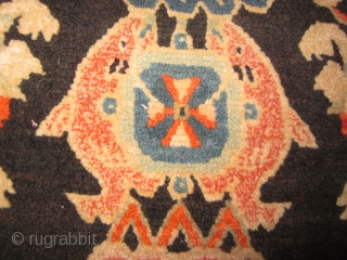 Tibetan mat as large pillow, 18 by 27 inches, note religious symbol of the conch shell, and also the two fish.            