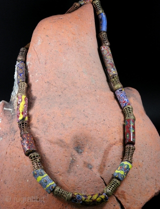 Venice Millefiori trade glass beads (1850-1950), bronze Baoule beads necklace.  From Mali, Africa

Size: lenght 70 cm; diameter of beads 0,8-1,5 cm

Bibl. Ref. Sherr Dubin "The history of beads"    