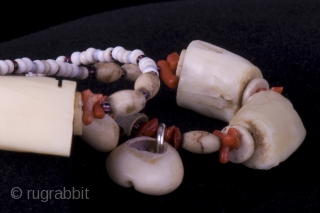 Necklace with Phacocerus teeth, shells, cauris, old red coral and snake vertebres from an old Congo gri-gri (fetish)
size : 
lenght:  41 cm 
diameter of beads: 0,1 - 2,5 cm

Bibl. ref.: Dubin, History of  ...