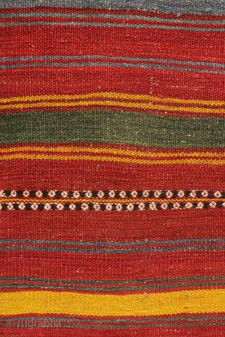 An antique kilim woven by an Uzbek weaver from Northern Afghanistan. The harmonious composition is achieved through the combination of wide plain bands with narrower bands decorated with small floral motifs, their  ...