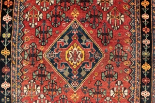 A Qashqai tribe rug with a central medallion, a central field full of floral bouquets, even the borders are arranged with flowers. All dyes are natural, achieving a pretty range of terracotas,  ...