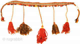 This antique band of the Qashqai tribe was woven from wool woven with natural dyes. The wool is finely spun, which allows a small and meticulous design to be made. The pompoms  ...
