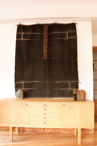 Originally this kilim was a large Qashqai camel bag that has been opened out to make a kilim. It is woven with undyed black goat´s hair and for the dyed areas sheep´s  ...