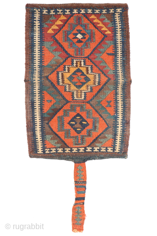 A rare Kurdish bag that has been opened out. This chanteh originally was folded in halve resulting in a square bag. The rectangular long and narrow strip was used to close the  ...