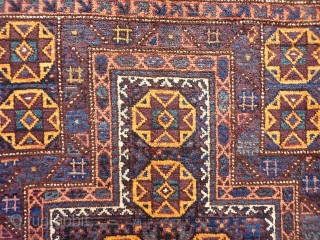 A coarsely woven Belouch prayer rug with a very tribal feel. The handling of the piece is similar to a loose gabbeh. Very soft and shinny wool. The field and the outside  ...