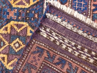 A coarsely woven Belouch prayer rug with a very tribal feel. The handling of the piece is similar to a loose gabbeh. Very soft and shinny wool. The field and the outside  ...