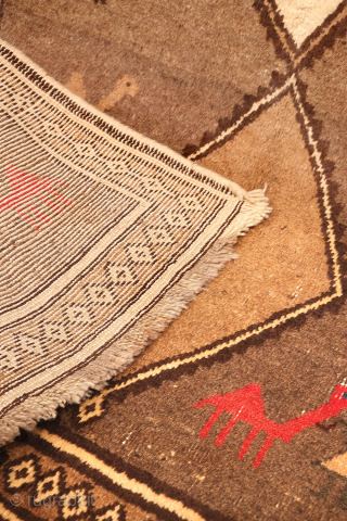 An unusual Qashqai gabbeh rug, likely woven with undyed natural camel wool. The rich color suggests the use of camel wool, and the weaver even included some camels in the design. Charming ...