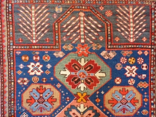 A Kuba rug with very vibrant natural colours and a nice design. The formality of the border and the mihrab contrasts with the introduction of animals and geometric floral motives throught the  ...