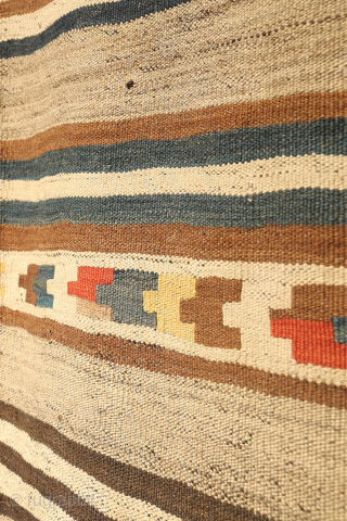 This antique kilim from the Qashqai tribes of Iran is a beautiful example of intuitive weaving and artistic expression. Woven with a blend of dyed and undyed wool, its primary design features  ...
