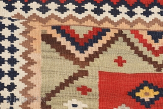 This antique kilim from the Qashqai tribe is woven from very finely spun and carded wool, thus creating a kilim of great precision. The center field has an "abrash" with spectacular color  ...