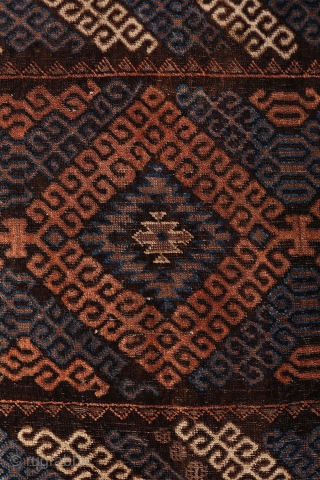 A very unusual Mushwani rug that carries the hooked design into the border. The rug has the traditional Mushwani design in natural colour indigo blue, terracotta and undyed white wool. Low overall  ...