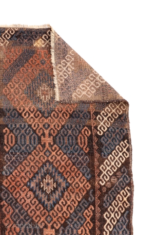 A very unusual Mushwani rug that carries the hooked design into the border. The rug has the traditional Mushwani design in natural colour indigo blue, terracotta and undyed white wool. Low overall  ...