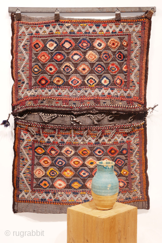 Are you searching for a truly unusual and original saddlebag? Look no further.

The captivating design of this antique Qashqai saddlebag was achieved using the warp-float weave technique. This specialized method is typically  ...