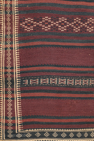 A beautiful antique Baluch kilim woven with finely hand-spun wool. This exceptionally dark antique kilim is difficult to photograph, and the images do not fully capture the richness of its natural colours ...