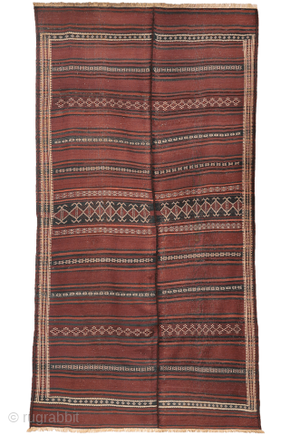 A beautiful antique Baluch kilim woven with finely hand-spun wool. This exceptionally dark antique kilim is difficult to photograph, and the images do not fully capture the richness of its natural colours ...
