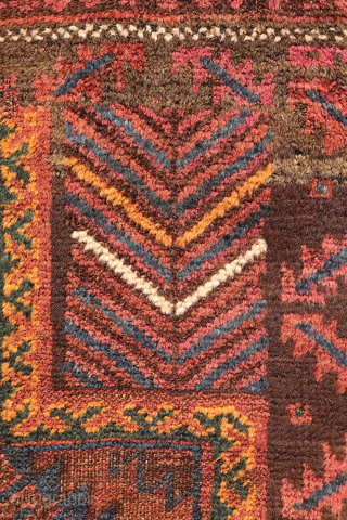 An antique Baluch prayer rug from Afghanistan, featuring an elegant, dark palette of natural dyes, including a deep indigo blue. The field contains two medallions, whose distinctive cross-shaped interior motif is echoed ...