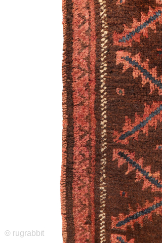 An antique Baluch prayer rug from Afghanistan, featuring an elegant, dark palette of natural dyes, including a deep indigo blue. The field contains two medallions, whose distinctive cross-shaped interior motif is echoed ...