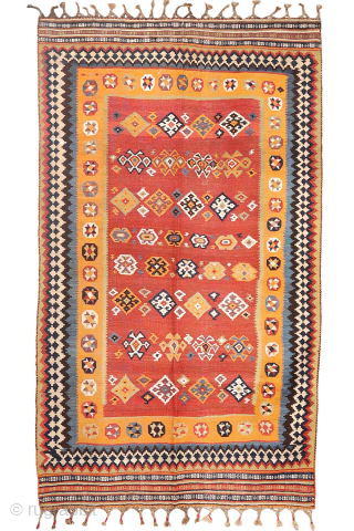 A superb antique Qashqai kilim showcasing a rich palette of natural colors. The background is dyed in what Persian weavers once called "copper" colour—a warm terracotta shade achieved with natural dyes. Upon  ...