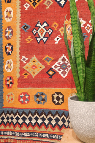 A superb antique Qashqai kilim showcasing a rich palette of natural colors. The background is dyed in what Persian weavers once called "copper" colour—a warm terracotta shade achieved with natural dyes. Upon  ...