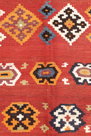 A superb antique Qashqai kilim showcasing a rich palette of natural colors. The background is dyed in what Persian weavers once called "copper" colour—a warm terracotta shade achieved with natural dyes. Upon  ...