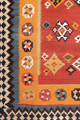 A superb antique Qashqai kilim showcasing a rich palette of natural colors. The background is dyed in what Persian weavers once called "copper" colour—a warm terracotta shade achieved with natural dyes. Upon  ...