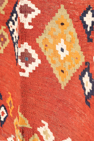A superb antique Qashqai kilim showcasing a rich palette of natural colors. The background is dyed in what Persian weavers once called "copper" colour—a warm terracotta shade achieved with natural dyes. Upon  ...