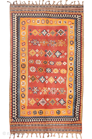A superb antique Qashqai kilim showcasing a rich palette of natural colors. The background is dyed in what Persian weavers once called "copper" colour—a warm terracotta shade achieved with natural dyes. Upon  ...
