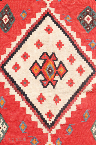This antique Qashqai kilim is a striking example of tribal weaving, created with rich, naturally dyed colors that have retained their depth and vibrancy over time.

The main field features a bold deep-red  ...