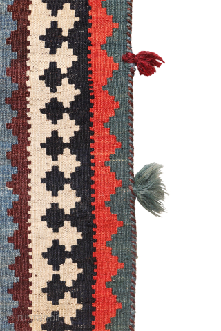 This antique Qashqai kilim is a striking example of tribal weaving, created with rich, naturally dyed colors that have retained their depth and vibrancy over time.

The main field features a bold deep-red  ...