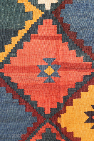 Antique Qashqai Kilim with gabbeh like Design.

This antique Qashqai kilim features a superb design brought to life with richly saturated natural dyes, including deep indigo blue, emerald green, and mustard tones. The  ...