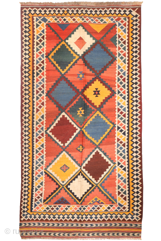 Antique Qashqai Kilim with gabbeh like Design.

This antique Qashqai kilim features a superb design brought to life with richly saturated natural dyes, including deep indigo blue, emerald green, and mustard tones. The  ...