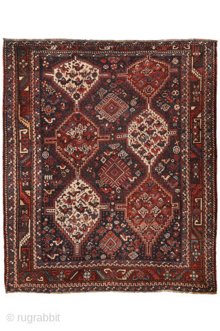 An antique Khamseh rug with a wonderful design and a very practical, almost square size.
The rug features two sets of medallions, each filled with numerous birds. These birds are repeated throughout the ...