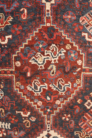 An antique Khamseh rug with a wonderful design and a very practical, almost square size.
The rug features two sets of medallions, each filled with numerous birds. These birds are repeated throughout the ...