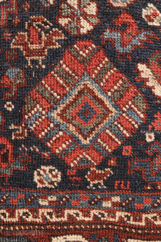 An antique Khamseh rug with a wonderful design and a very practical, almost square size.
The rug features two sets of medallions, each filled with numerous birds. These birds are repeated throughout the ...