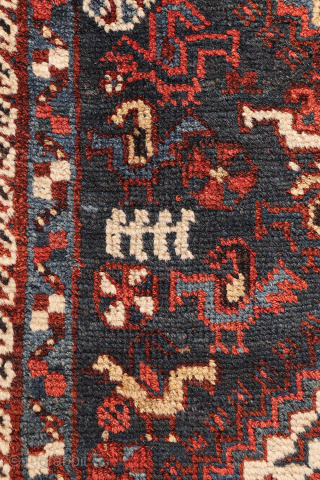 An antique Khamseh rug with a wonderful design and a very practical, almost square size.
The rug features two sets of medallions, each filled with numerous birds. These birds are repeated throughout the ...