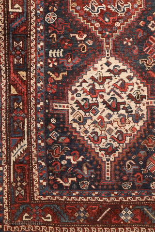 An antique Khamseh rug with a wonderful design and a very practical, almost square size.
The rug features two sets of medallions, each filled with numerous birds. These birds are repeated throughout the ...